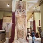 Egyptian statue leaned on a pillar