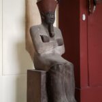Egyptian statue against white wall