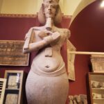 Egyptian statue with broken arm