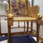 golden chair with paws for chair legs